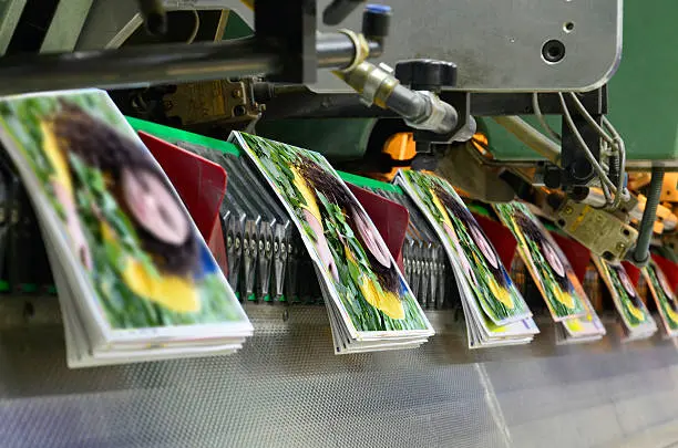 Brochure and magazine stitching process. Close-up of the  offset conveying process of a full-automatic stitching unit.